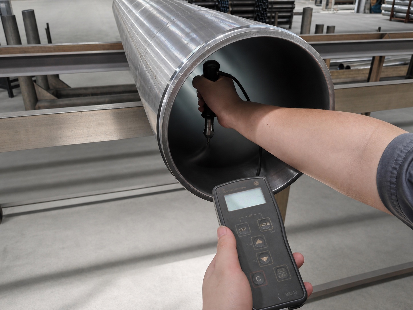 A handheld hardness tester checking the chrome layer inside a Tianhou delivery cylinder