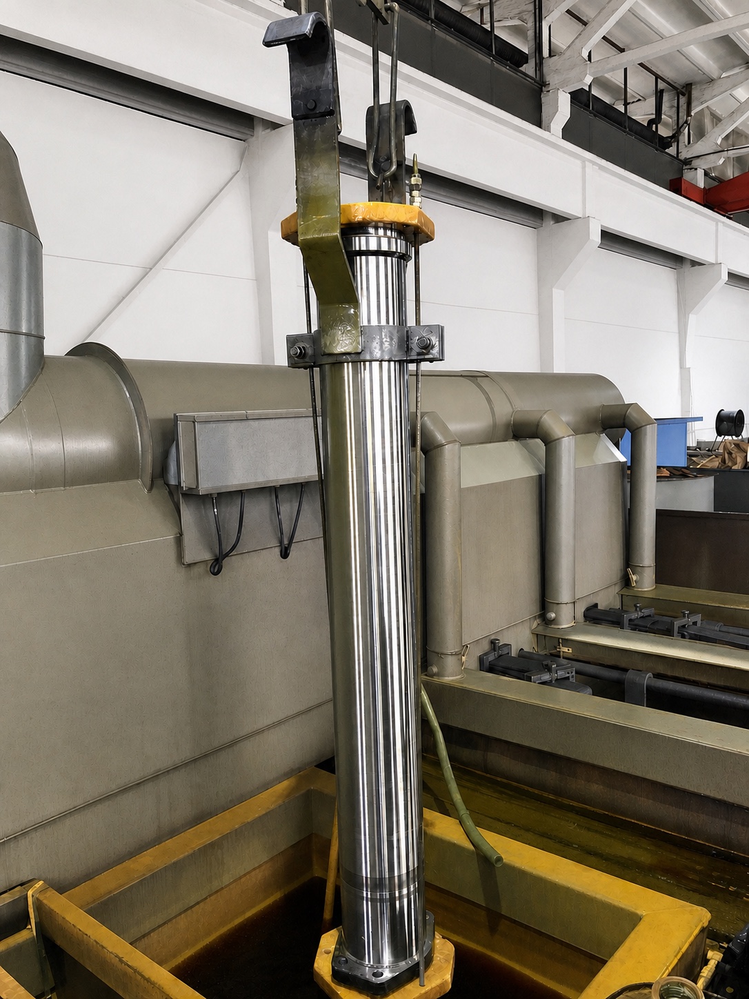 A concrete pump delivery cylinder with a special flange suspended in Tianhou chrome-plating equipment