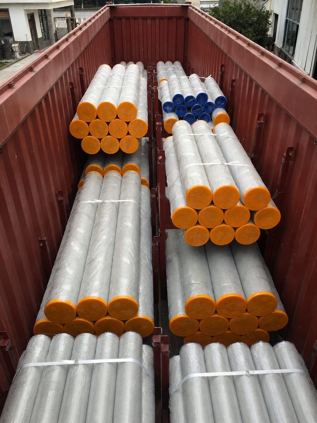 Wrapped delivery cylinders packed in an open shipping container with identifying labels removed